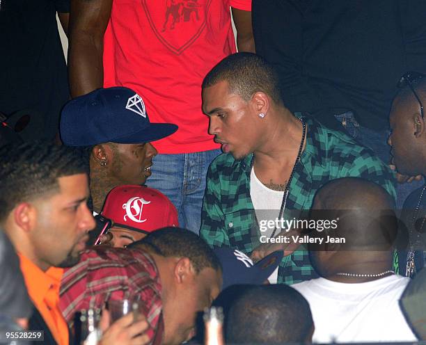 Lil Wayne and Chris Brown attend a party presented by Bartley International in association with the 400 Club at Play Nightclub on January 1, 2010 in...