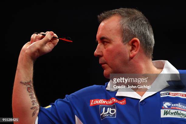 Phil Taylor of England in action against Mark Webster of Wales during the Semi Finals of the 2010 Ladbrokes.com World Darts Championships at...