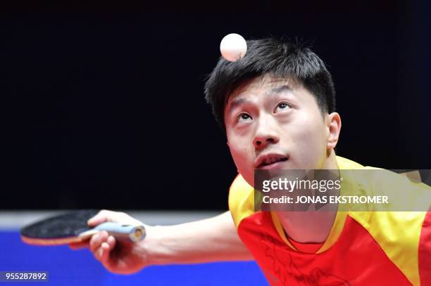 Long Ma of China eyes the ball as he plays against Germany's Timo Boll during the men's final at the World Team Table Tennis Championships in...