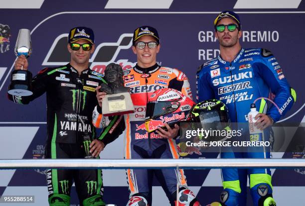 First placed Repsol Honda Team's Spanish rider Marc Marquez , second placed Monster Yamaha Tech 3's French rider Johann Zarco and third placed Team...