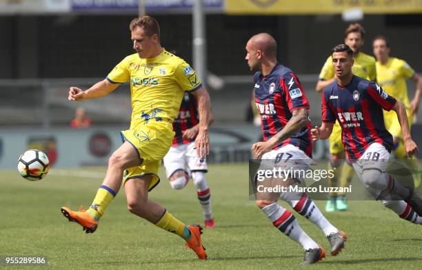 Valter Birsa of AC Chievo Verona is challenged by Bruno Martella of FC Crotone during the serie A match between AC Chievo Verona and FC Crotone at...