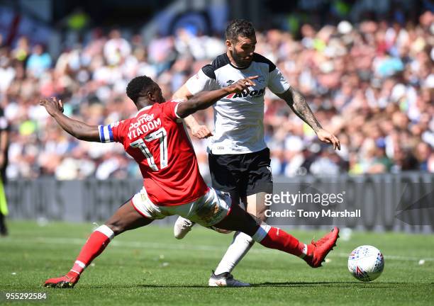 BradleyJohnson of Derby County is tackled by Andy Yiadom of Barnsley during the Sky Bet Championship match between Derby County and Barnsley at iPro...