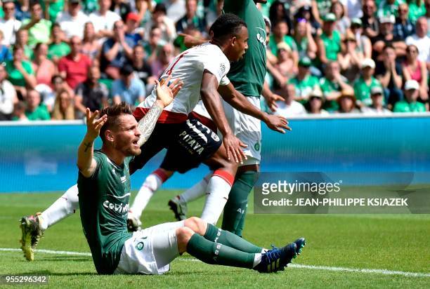 Bordeaux's French defender Jules Kounde celebrates after scoring a goal next to Saint-Etienne's French defender Mathieu Debuchy reacting during the...