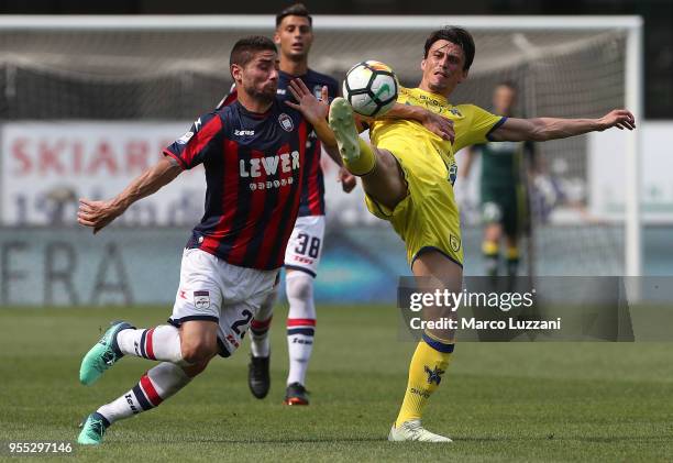 Roberto Inglese of AC Chievo Verona competes for the ball with Marco Capuano of FC Crotone during the serie A match between AC Chievo Verona and FC...