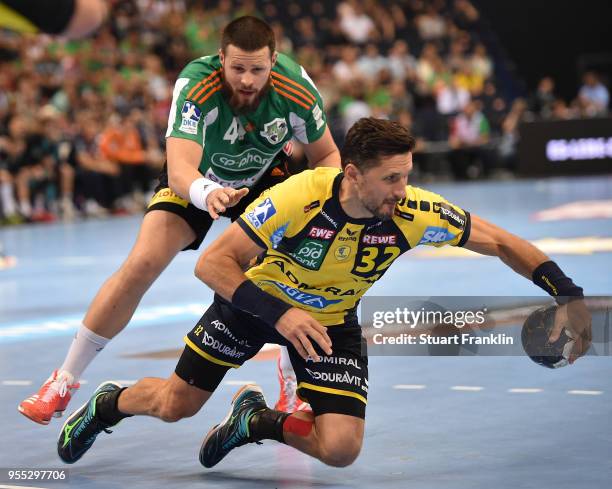 Ilija Brozovi of Hannover challenges Alexander Petersson of Rhein-Neckar during the final of the DKB Handball Bundesliga Final Four between Hannover...