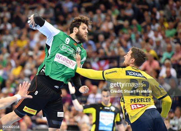 Mait Patrail of Hannover is challenged by Hendrik Pekeler of Rhein-Neckar during the final of the DKB Handball Bundesliga Final Four between Hannover...