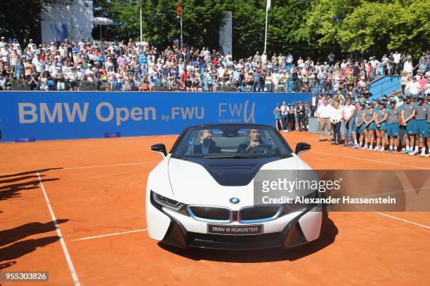 Alexander Zverev of Germany drives with Oliver Zipse, member of the BMW Board the winners car, a BMW i8 Roadster after winning his finalmatch against...