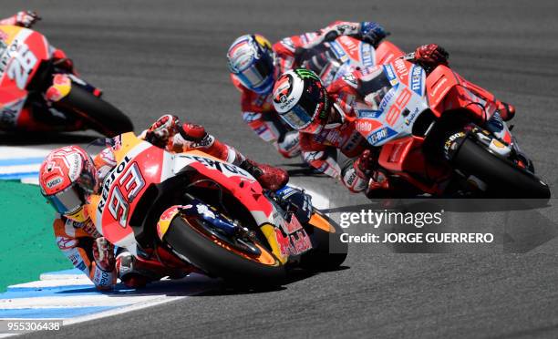 Repsol Honda Team's Spanish rider Marc Marquez and Ducati Team's Spanish rider Jorge Lorenzo compete during the MotoGP race of the Spanish Grand Prix...