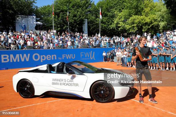 Alexander Zverev of Germany poses with the winners trophy and the winners car, a BMW i8 Roadster after winning his finalmatch against Philipp...