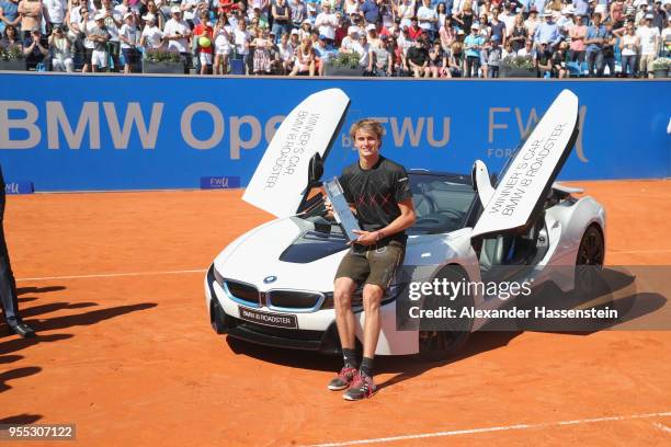 Alexander Zverev of Germany poses with the winners trophy and the winners car, a BMW i8 Roadster after winning his finalmatch against Philipp...