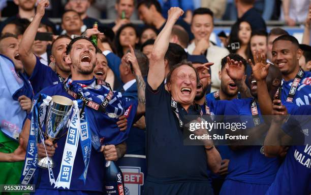 Cardiff captain Sean Morrison and manager Neil Warnock celebrate promotion to the premier league after the Sky Bet Championship match between Cardiff...