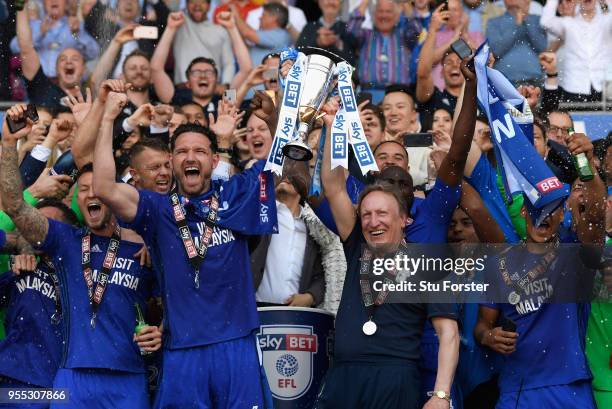 Cardiff captain Sean Morrison and manager Neil Warnock celebrate promotion to the premier league with the squad after the Sky Bet Championship match...