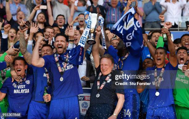 Cardiff captain Sean Morrison and manager Neil Warnock celebrate promotion to the premier league with the squad after the Sky Bet Championship match...