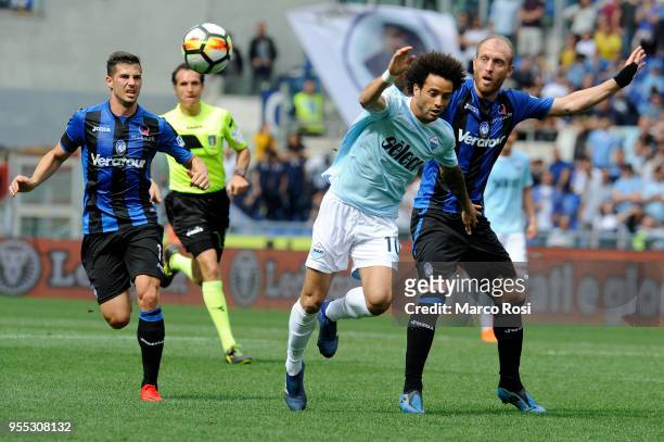 Felipe Anderson of SS Lazio compete for the ball with Andrea Masiello Atalanta BC during the serie A match between SS Lazio and Atalanta BC at Stadio...