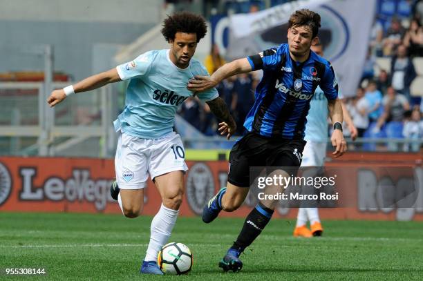 Felipe Anderson of SS Lazio compete for the ball with Marten De Roon Atalanta BC during the serie A match between SS Lazio and Atalanta BC at Stadio...