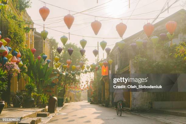 woman walking in hoi an in the morning - vietnam stock pictures, royalty-free photos & images