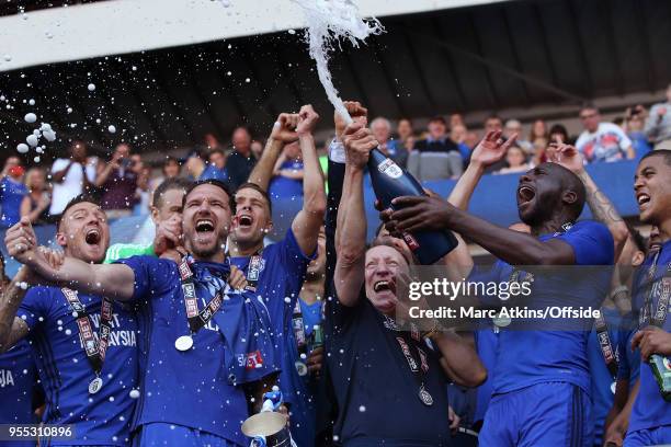 Cardiff City manager Neil Warnock celebrates among his players as they spray Champagne during the Sky Bet Championship match between Cardiff City and...