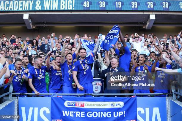 Sean Morrison of Cardiff City and Cardiff City manager Neil Warnock lift the trophy after being automatically promoted to the Premier League after...