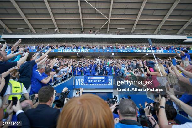 Sean Morrison of Cardiff City and Cardiff City manager Neil Warnock lift the trophy after being automatically promoted to the Premier League after...