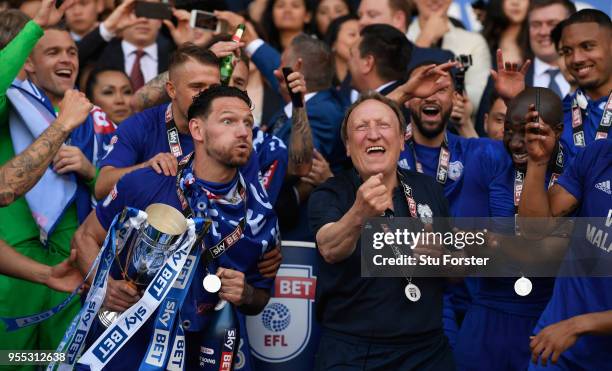 Cardiff captain Sean Morrison and manager Neil Warnock celebrate promotion to the premier league after the Sky Bet Championship match between Cardiff...