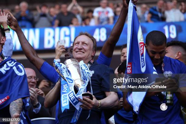 Cardiff City manager Neil Warnock celebrates as he holds the trophy during the Sky Bet Championship match between Cardiff City and Reading at Cardiff...