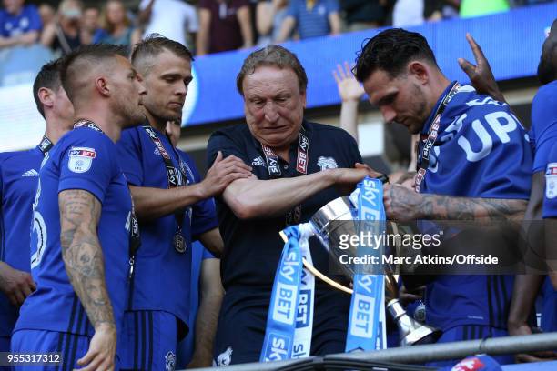 Cardiff City manager Neil Warnock stumbles as he reaches for the trophy during the Sky Bet Championship match between Cardiff City and Reading at...