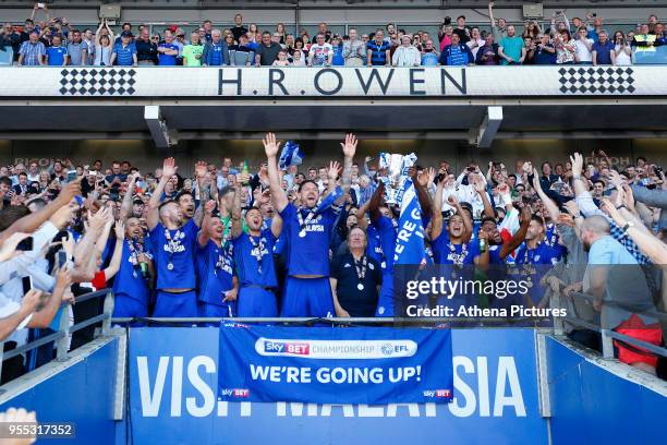 Sean Morrison of Cardiff City and Sol Bamba lifts the trophy after being automatically promoted to the Premier League after the final whistle of the...