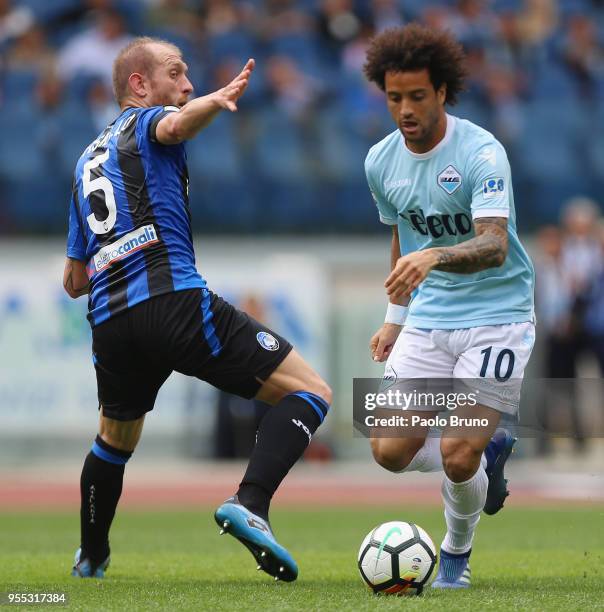 Felipe Anderson of SS Lazio competes for the ball with Andrea Masiello of Atalanta BC during the Serie A match between SS Lazio and Atalanta BC at...