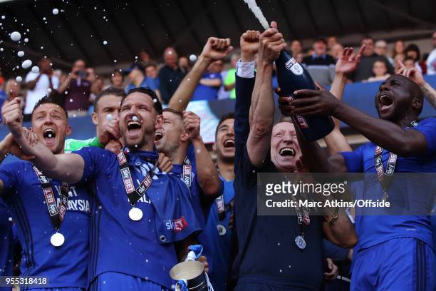 Cardiff City manager Neil Warnock celebrates among his players as they spray Champagne during the Sky Bet Championship match between Cardiff City and...