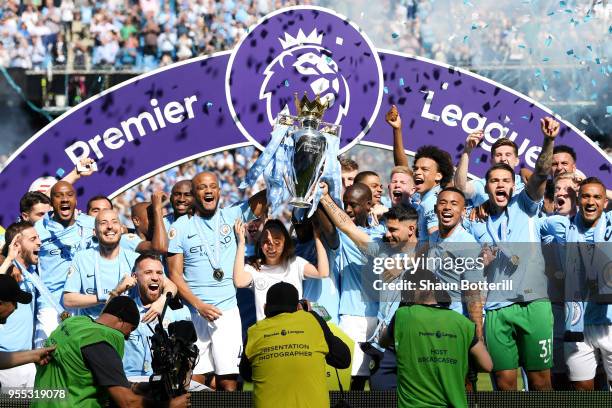 Vincent Kompany of Manchester City lifts the Premier League Trophy as Manchester City celebrate winning the Premier League after the Premier League...