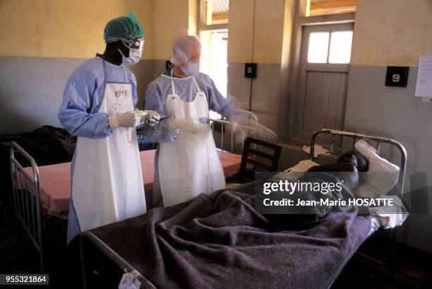 American and Ugandan physicians try to take care of patients.