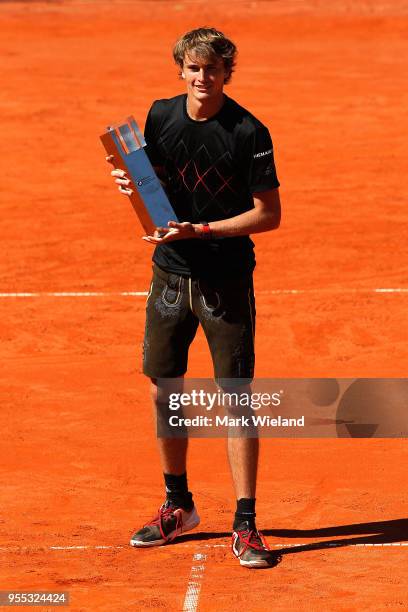 Alexander Zverev of Germany celebrates with the winner's trophy after beating Philipp Kohlschreiber of Germany during the final on day 9 of the BMW...