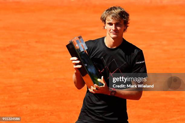 Alexander Zverev of Germany celebrates with the winner's trophy after beating Philipp Kohlschreiber of Germany during the final on day 9 of the BMW...