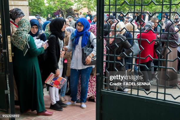 Moroccan women arrive to sit an exam on May 6 in the capital Rabat, to become a notary in Islamic law, known locally as an "Adoul", after the...