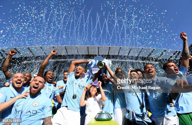 Vincent Kompany of Manchester City lifts the Premier League Trophy as Manchester City celebrate winning the Premier League after the Premier League...