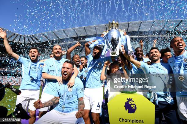 Vincent Kompany of Manchester City lifts the Premier League Trophy as Manchester City celebrate winning the Premier League after the Premier League...