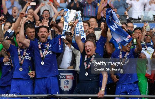 Cardiff captain Sean Morrison and manager Neil Warnock celebrate promotion to the premier league with the squad after the Sky Bet Championship match...