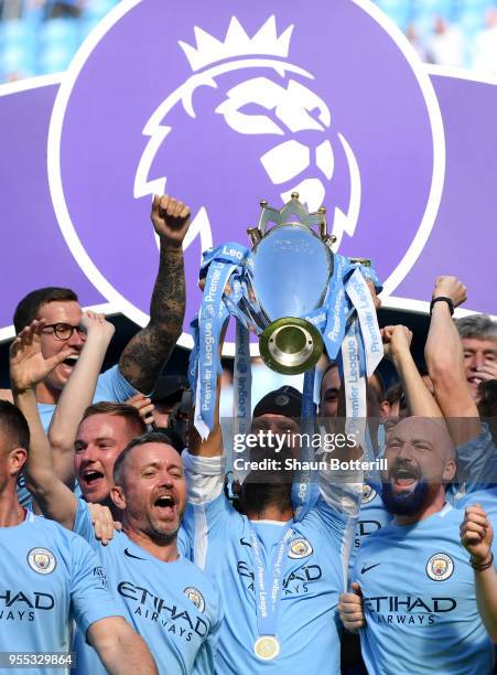 Josep Guardiola, Manager of Manchester City lifts The Premier League Trophy after the Premier League match between Manchester City and Huddersfield...