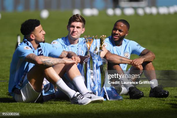 Kyle Walker of Manchester City , John Stones of Manchester City and Raheem Sterling of Manchester City celebrates with The Premier League Trophy...