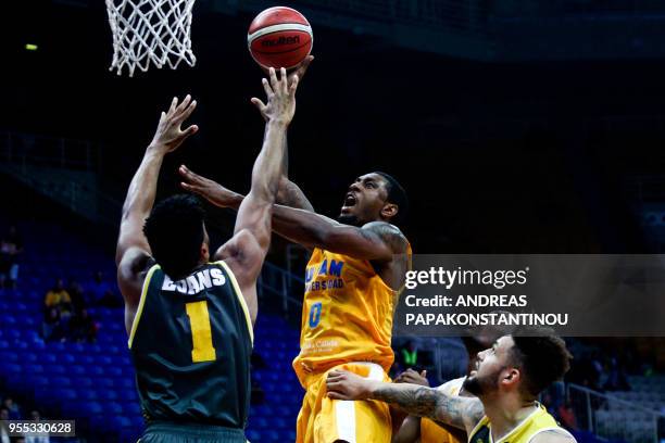 Riesen Ludwigsburg's Dwayne Evans vies with UCAM Murcia's Ovle Soko during the final four Champions League basketball 3rd place game between Riesen...