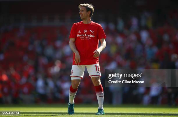 Nacho Monreal of Arsenal warms up whilst wearing a 'Merci Arsene' t shirt prior to the Premier League match between Arsenal and Burnley at Emirates...