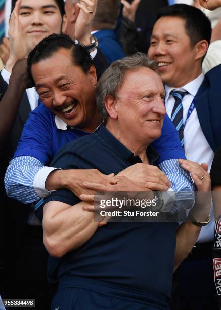 Cardiff owner Vincent Tan and manager Neil Warnock celebrate promotion to the premier league after the Sky Bet Championship match between Cardiff...