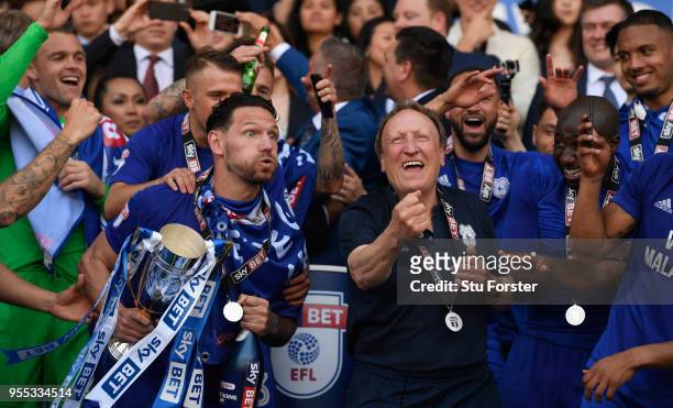 Cardiff captain Sean Morrison and manager Neil Warnock celebrate promotion to the premier league after the Sky Bet Championship match between Cardiff...