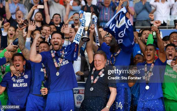 Cardiff captain Sean Morrison and manager Neil Warnock celebrate promotion to the premier league with the squad after the Sky Bet Championship match...