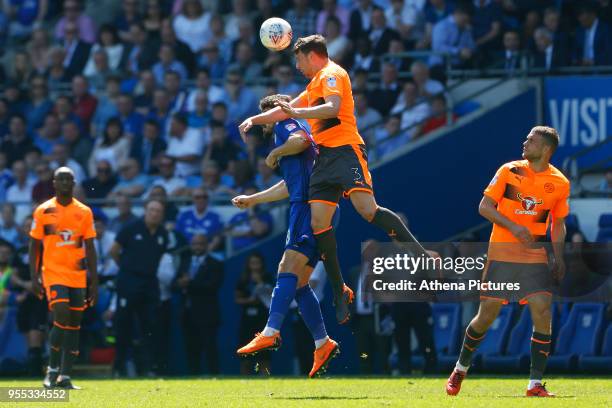 Tommy Elphick of Reading heads the ball away Callum Paterson of Cardiff City during the Sky Bet Championship match between Cardiff City and Reading...