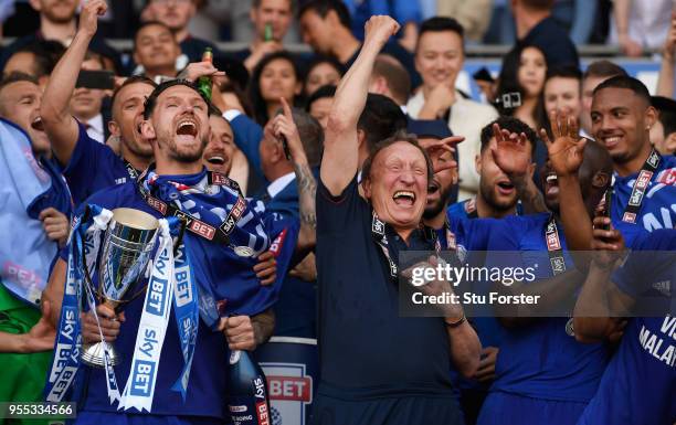 Cardiff captain Sean Morrison and manager Neil Warnock celebrate promotion to the premier league after the Sky Bet Championship match between Cardiff...