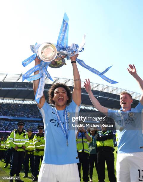 Leroy Sane of Manchester City celebrate with The Premier League Trophy after the Premier League match between Manchester City and Huddersfield Town...