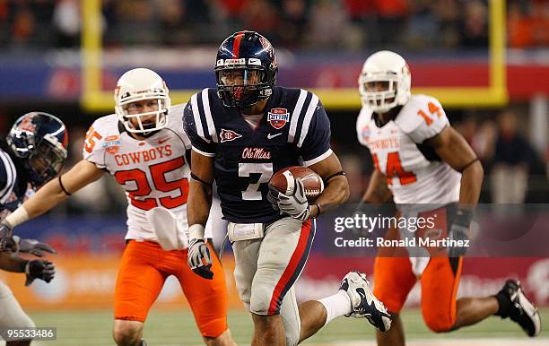Patrick Trahan of the Mississippi Rebels returns a fumlbe recovery for a touchdown against the Oklahoma State Cowboys during the AT&T Cotton Bowl on...