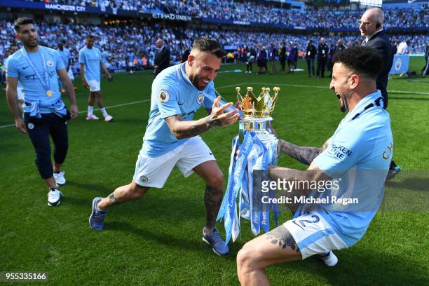 Nicolas Otamendi of Manchester City and Kyle Walker of Manchester City celebrate with The Premier League Trophy after the Premier League match...