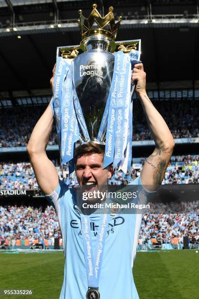 John Stones of Manchester City celebrates with The Premier League Trophy after the Premier League match between Manchester City and Huddersfield Town...